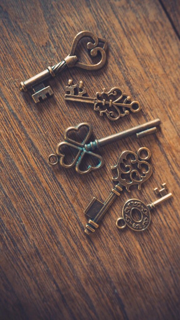 five old fashioned keys on table
